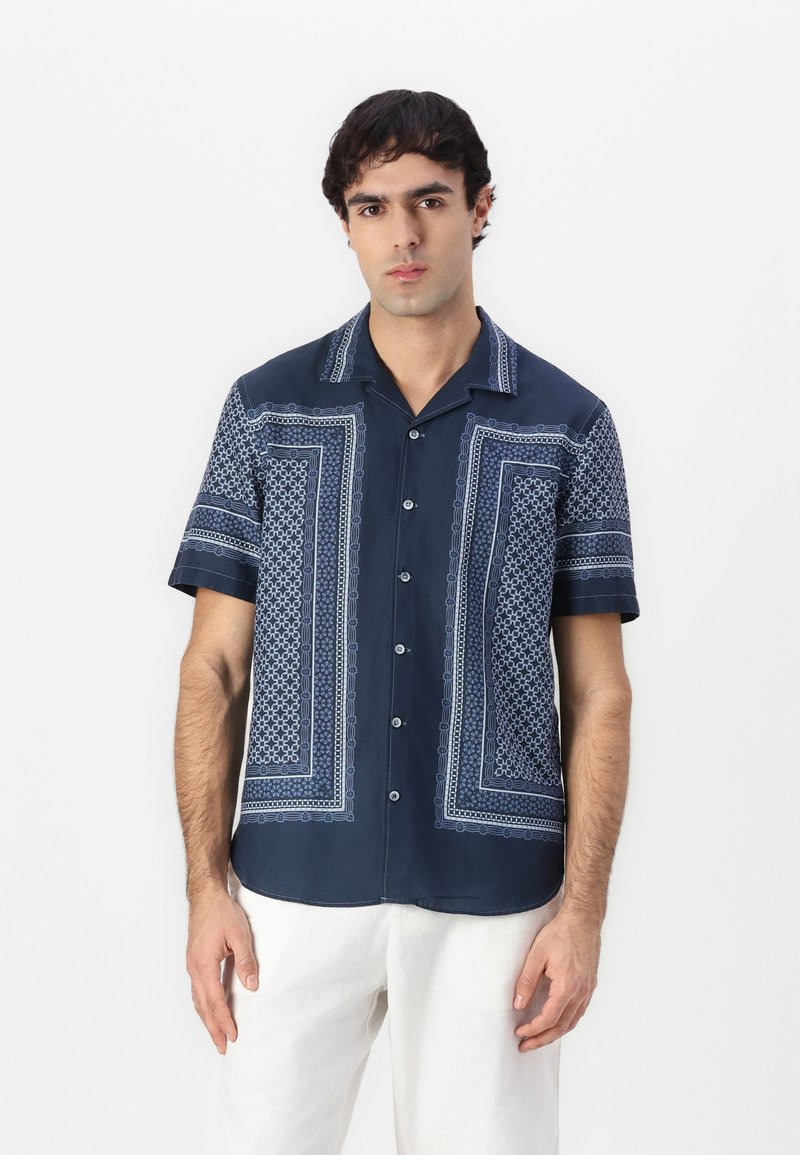 Navy short-sleeve shirt featuring intricate light blue geometric patterns, button front closure, and a camp collar design.