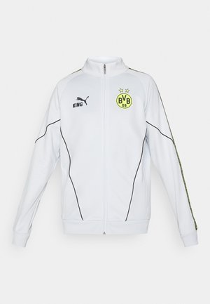 Biele puma mikina na zips s čiernym lemovaním, žlté logo Borussia Dortmund BVB 09 s dvoma hviezdami a text "KING" na hrudi.