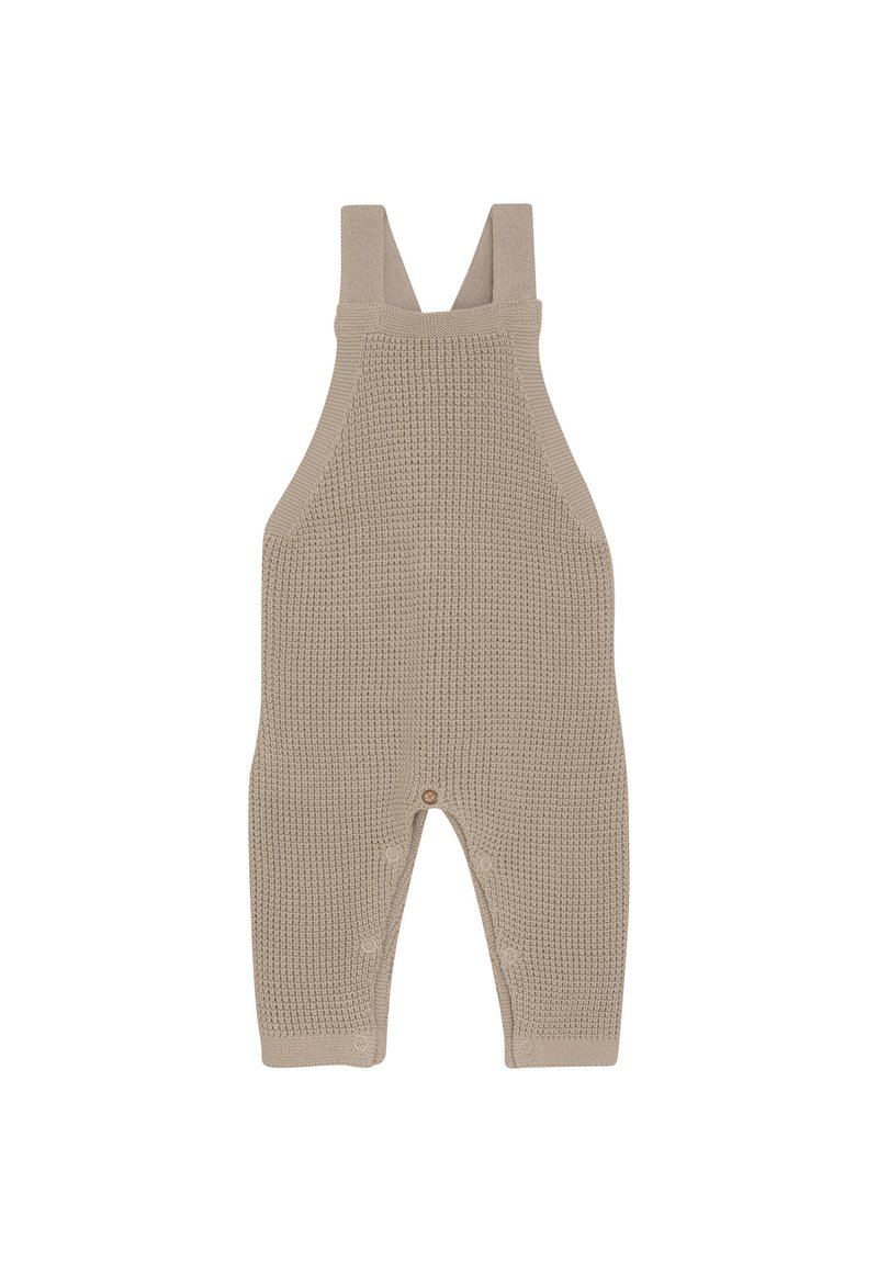 Beige gebreide baby romper met verstelbare schouderbandjes en drukknoopjes langs de binnenbeennaad voor gemakkelijke luierwissels.