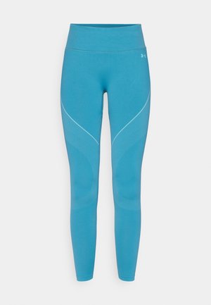 Kék sport leggings rugalmas anyagból, ívelt varrásdíszítésekkel és texturált mintákkal az oldalakon. Magas derekú kialakítás.