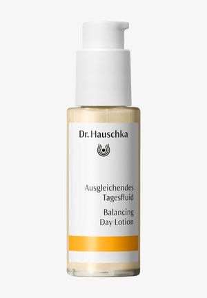 Dr. Hauschka Balancing Day Lotion in a clear pump bottle with white and orange label showing brand and product name.