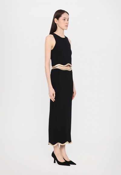 Black sleeveless dress with a wavy gold band at the waist and gold scalloped hem. Smooth fabric, floor-length with a fitted silhouette.