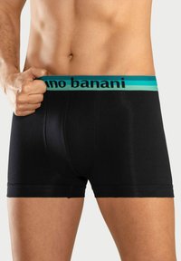 Svarta boxer-kalsonger med en åtsittande design, med ett midjeband i teal och svart med varumärkeslogotyp. Tillverkade av ett slätt, stretchigt material.