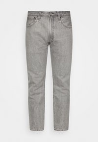 Harmaat farkut suoran leikkauksen, viiden taskun ja erottuvan ompelun kanssa. Omaavat haalistuneen värin ja nappisulkemisen.