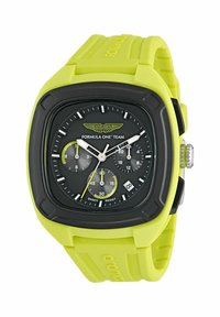 Zöld szilikon szíjas karóra, fekete négyzet alakú számlappal, ezüst órajelzőkkel, krónográf mutatókkal és dátumablakkal.
