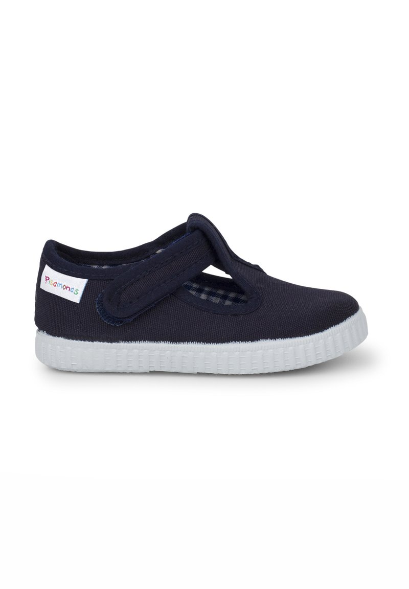 Zapato Mary Jane de lienzo en color navy con correa de Velcro, suela de goma blanca y forro de patrón a cuadros. Presenta una puntera redondeada y un diseño flexible.