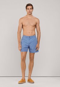 Costume da bagno blu con un design geometrico, dotato di chiusura a bottone e vita elasticizzata. Realizzato in tessuto leggero.