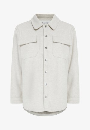 Helehall shirt-kate, mis on valmistatud pehmest kangast, kaasas krae, kaks rinna taskut ja ees nupuga sulgemine. Kergelt kaardus helm.