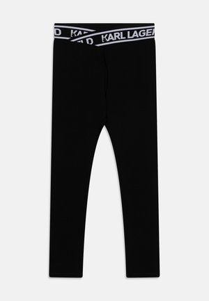 Zwarte legging gemaakt van zachte stof, met een brede tailleband voorzien van een contrasterend wit "KARL LAGERFELD" logo. Soepele textuur.