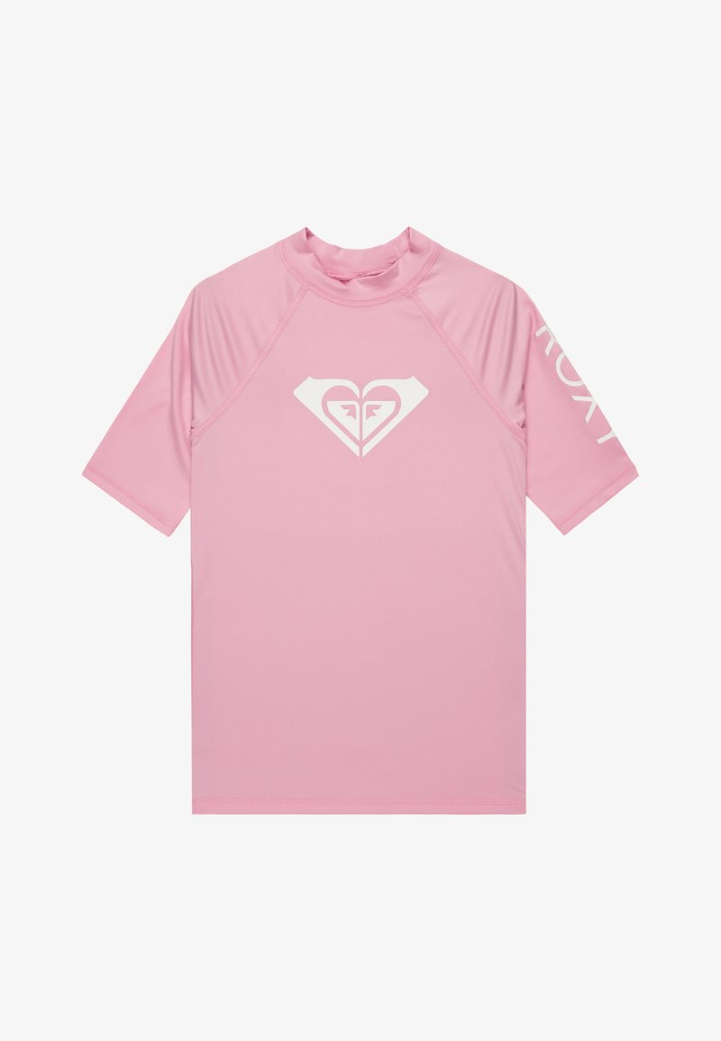 Short-sleeve rash guard in light pink, made of stretchy fabric. Features a white heart logo on the chest and "ROXY" printed on the sleeve.