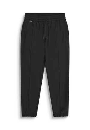 Pantaloni neri con vita elastica e coulisse, tasche laterali, gambe strette e polsini elastici su sfondo bianco.