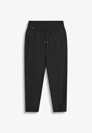 Pantaloni neri con vita elastica e coulisse, tasche laterali, gambe strette e polsini elastici su sfondo bianco.