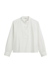 Valkoinen pitkähihainen paita, joka on valmistettu puuvillasta. Ominaisuuksina pyöreä kaula-aukko, nappilista ja löysä istuvuus. Miellyttävä pinta ja kevyt muotoilu.