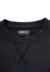 Black sweatshirt with ribbed crew neck, featuring visible stitching in an X pattern and a label reading "HONESTY RULES," size L.