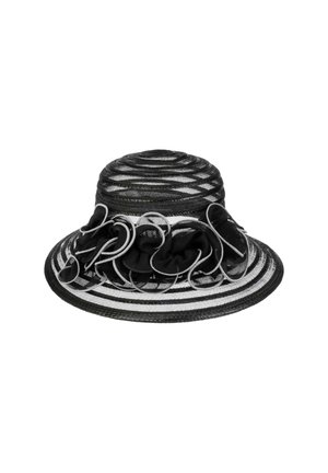 Black and white striped hat with a round crown, featuring a ruffled black fabric accent and curved white loops along the brim.