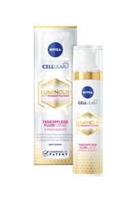 NIVEA Cellular Luminous 630 anti-pigmentation fluid in a clear pump bottle. White and gold packaging with hexagonal design and logo.