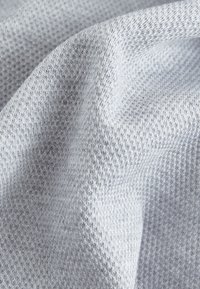 Light gray textured fabric with a fine, woven pattern, showcasing a soft, smooth surface and slight sheen.