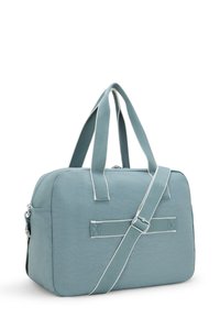 Teal fabric duffel bag with rounded edges, dual handles, and a detachable shoulder strap. Features white stitching and a zip closure.