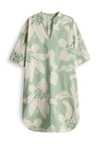 Green floral tunic with short sleeves, deep neckline, and white flowers with green accents. Smooth fabric with a relaxed, oversized fit.