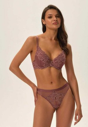 Mauve lace bra with floral patterns, featuring adjustable straps and a plunging neckline. Matching sheer thong with detailed accents.