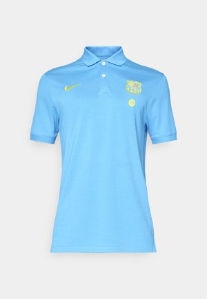 Light blue polo shirt with a collar, short sleeves, Nike logo, and Barcelona crest in yellow. Made from smooth fabric.