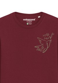 Burgundy long-sleeve t-shirt in soft cotton blend features a green outline graphic of a bird with the text "self love" and floral accents.