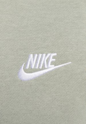 Light green fabric with a textured knit; features an embroidered white "NIKE" logo with a swoosh accent.
