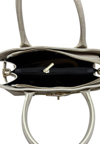 Widok z góry na beżową skórzaną torebkę z podwójnymi uchwytami, ukazującą rozpiętą główną komorę i czarną wewnętrzną kieszeń na zamek.