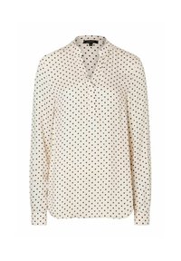 Crème blouse met lange mouwen, voorzien van een kraag en een zwart stippenpatroon over de hele stof. Gemaakt van lichtgewicht, soepel materiaal.