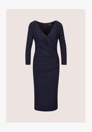 Navy blue dress with long sleeves and a V-neck, featuring a wrapped design and textured, slightly sparkly fabric. Zipper at the back.