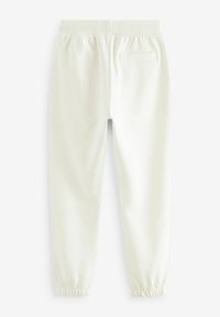 Hvide bomulds joggers med elastisk talje, ribbede kanter og en enkelt baglomme. Blød tekstur og minimalistisk design.