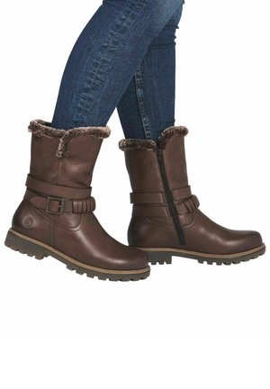 Braune Lederstiefel mit strukturierter Oberfläche, mit fellgefütterten Abschlüssen, einem seitlichen Reißverschluss und einem Schnallenakzent. Robuste Gummisohle für guten Halt.