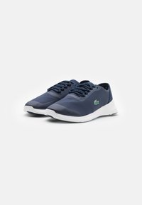 Navy lightweight sneakers with textured upper, white outsole, and dark blue laces. Features a small green logo on the side.