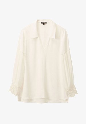 Blouse blanche avec un col, décolleté en V et manches trois-quarts. Présente des accents brodés décoratifs sur les poignets. Tissu doux.