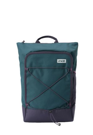 Dark green and navy backpack with front bungee cord, top handle, and zippered front pocket, branded with AEVOR logo.