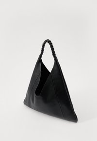 Black leather tote bag with a triangular shape, featuring a woven handle and open top. The surface has a textured finish.