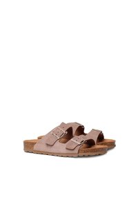 Brown suede sandals with two adjustable straps, silver buckles, and a textured cork footbed. Flat sole with a slight contour.