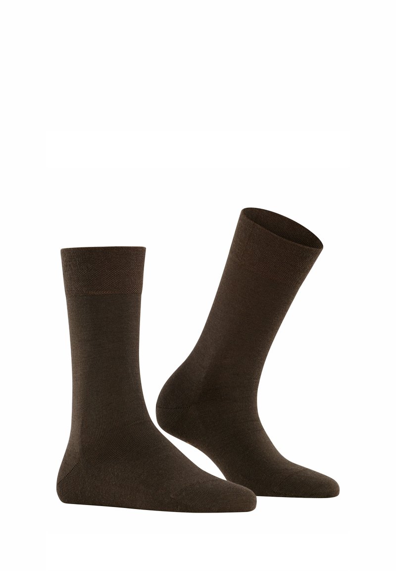Chaussettes en coton marron avec une bordure côtelée, une texture lisse et une longueur mi-mollet. Design simple sans motifs ni accents visibles.