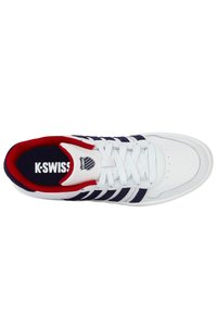 White athletic shoe with navy and red accents, featuring a smooth leather upper, round toe, lace-up design, and padded collar. K-Swiss logo visible.