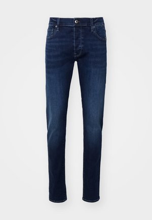 Dark blue denim jeans with a straight cut, featuring a button closure, belt loops, and five-pocket design. Smooth texture with subtle fading.