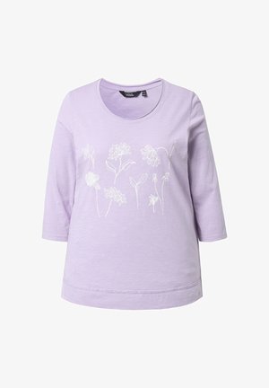 Chemise lilas à manches trois-quarts avec des motifs floraux en line art blanc sur la poitrine et un col rond.