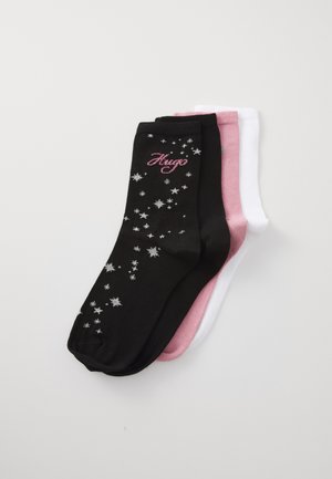 Three pairs of socks: black with silver stars and "Hugo" text, pink, and white. They feature a smooth texture and standard crew length.