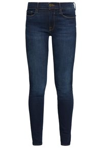Tmavě modré skinny džíny vyrobené z denimu, s pěti kapsami, zipem a knoflíkovým zapínáním s kontrastním prošíváním.