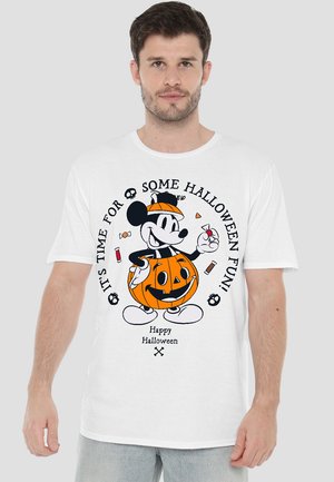 White cotton t-shirt featuring a Halloween-themed graphic of a smiling pumpkin with Mickey Mouse, surrounded by candy and text.