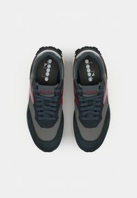 Dark grey sneakers with light grey mesh upper, maroon accents, and black laces. Features a thick rubber sole and cushioned interior.