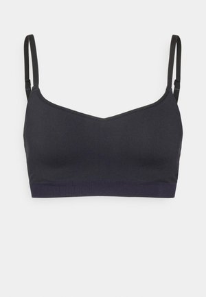Zwarte bralette met dunne verstelbare bandjes, een v-halslijn, gladde stof en een stretchy ribgebande onderkant.