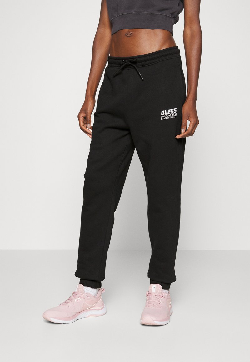 Guess ALISHA LONG Tracksuit bottoms jet black/black Zalando.co.uk