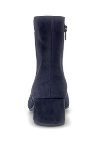 Navy suede ankle boot with a block heel, back zipper, and smooth texture. Features a fitted silhouette and rounded toe design.
