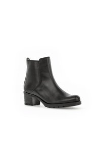 Bottines en cuir noir avec un bout arrondi, un petit talon large et des panneaux élastiques sur les côtés ; présente une texture lisse et un minimalisme dans les détails.