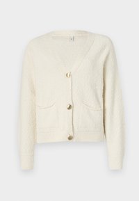 Cremefarvet cardigan med V-hals, tre guldknapper og to forlommer. Struktureret stof med ribbede manchetter og kant.